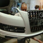 Before and after photographs of a damaged white, AUDI Quattro SUV that was repaired by Elite Paint & Body Shop in West Palm Beach, Florida.